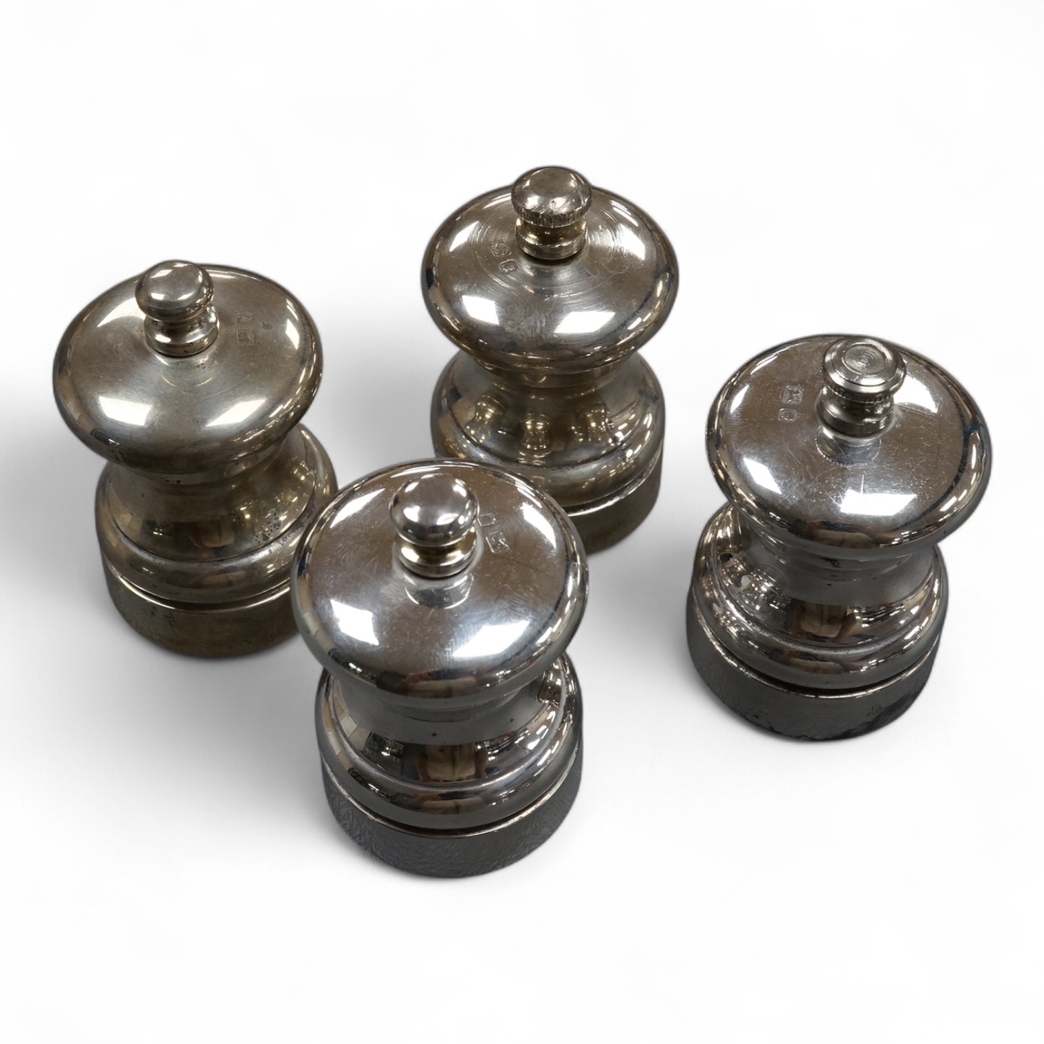 Four modern silver mounted salt and pepper mills, M C Hersey & Son Ltd, London, 1990/91/92, height 70mm.